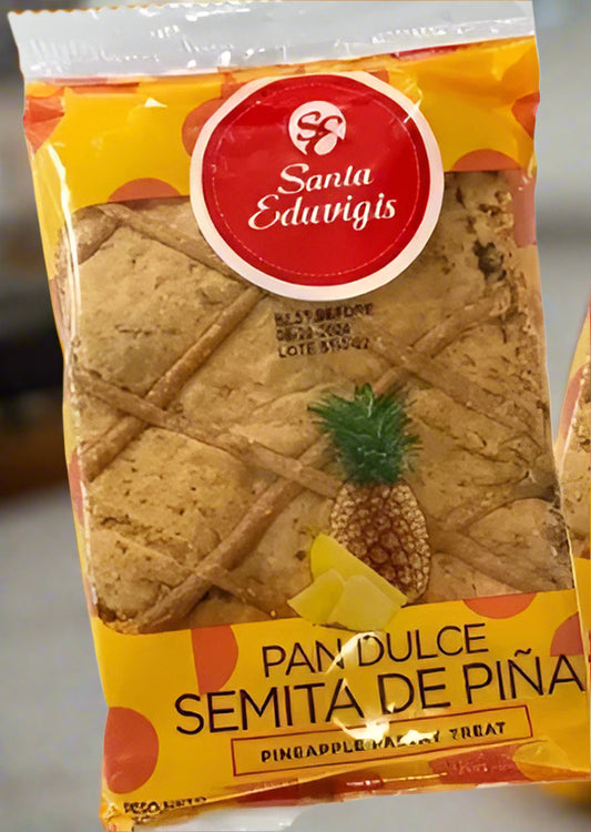 Packaged pineapple cookies with Santa Eduvigis branding on a yellow background
